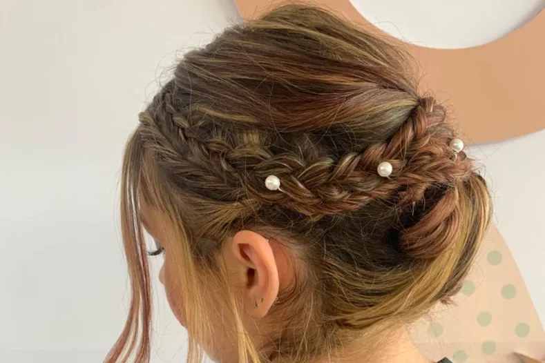 Braided bridal updo finished with pearl hair pins